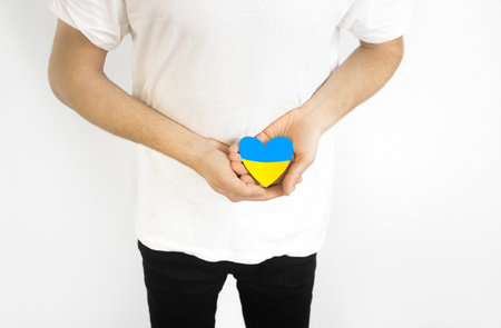Love Ukraine concept. Hands in the shape of a heart are painted in the color of the flag of Ukraine - yellow and blue. selective focus. Independence Day of Ukraine, flagの写真素材