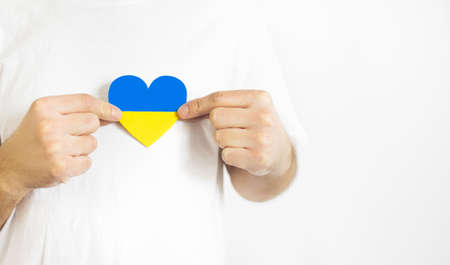 Love Ukraine concept. Hands in the shape of a heart are painted in the color of the flag of Ukraine - yellow and blue. selective focus. Independence Day of Ukraine, flagの写真素材