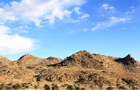 The bright blue sky above the mountainsの写真素材