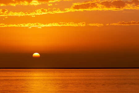 Beautiful golden sunset and bright sky over the lagoonの写真素材