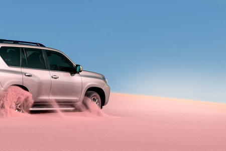 Close up of a golden car stuck in the sand in the Namib desert. Africa