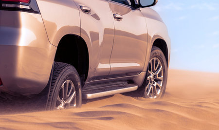 Close up of a golden car stuck in the sand in the Namib desert. Africa
