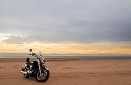 Off-road motorcycle parked in the desert under dramatic cloudy sky â adventure, travel, freedom, and extreme outdoor landscape conceptの写真素材