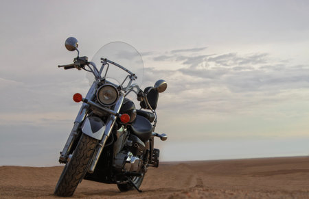Real photo of a  motorcycle stands still beneath a vibrant sunset, symbolizing freedom, adventure, and the thrill of exploring new roads ahead.の写真素材