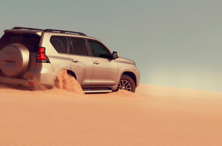 Close-up of an off-road vehicle stuck in deep sand in the Namib Desert, Namibia. Captures real conditions of travel, terrain challenges, and adventure.の写真素材