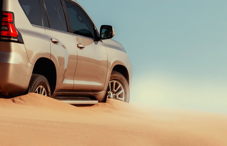 Close-up of an off-road vehicle stuck in deep sand in the Namib Desert, Namibia. Captures real conditions of travel, terrain challenges, and adventure.の写真素材