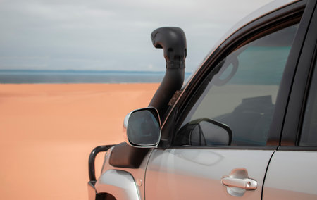 A powerful gray 4x4 SUV stands alone in the vast sandy terrain of the Namib Desert, ready for off-road travel, exploration, and endurance across one of Africaâs wildest landscapes.の写真素材