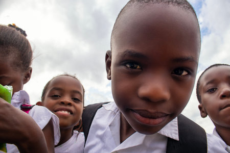 Premium close-up of happy African schoolchildren in uniforms, laughing together outdoors. A powerful and uplifting image capturing real joy, childhood, and cultural connection.の写真素材