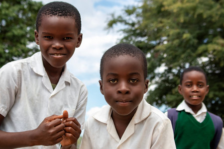 Premium close-up of happy African schoolchildren in uniforms, laughing together outdoors. A powerful and uplifting image capturing real joy, childhood, and cultural connection.の写真素材