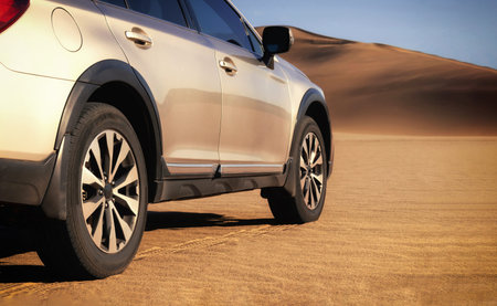 Brown SUV parked on sunlit desert terrain, capturing the bold spirit of off-road travel through the...