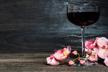 wine glass with champagne and pink orchidの写真素材