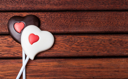 candy made of black whit chocolate and in the heart shaped on stickの写真素材