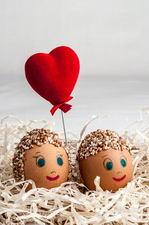 diy handmade little men from eggs and red heartの写真素材