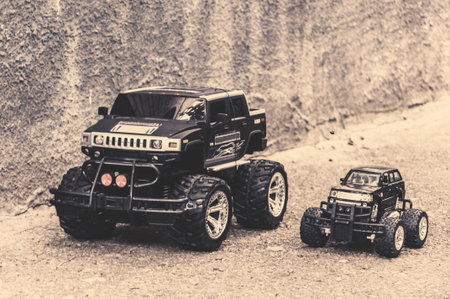 Two toy cars parked near the gray wall