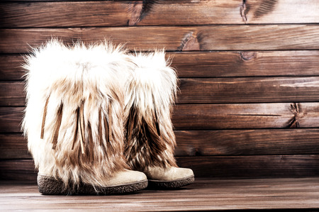 stylish women's winter boots with brown furの写真素材