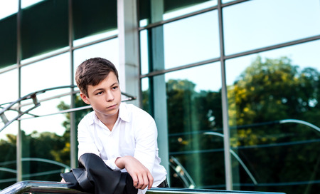 serious teenager in a suit near the business centerの写真素材
