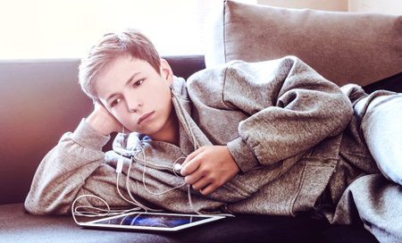 teenager with tablet while lying on the floor in the room