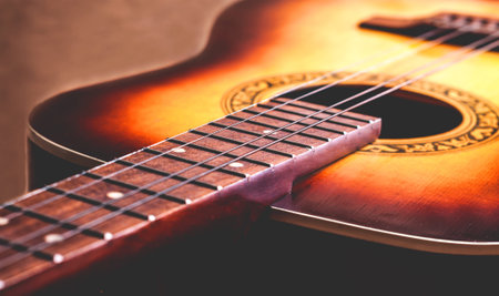 classical yellow guitar of wood Part fretboard and stringsの写真素材