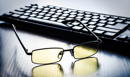 yellow glasses to eye protection near the keyboard