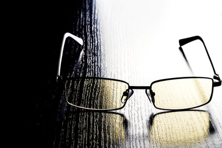 modern glasses to eye protection with yellow lenses on a contrasting background