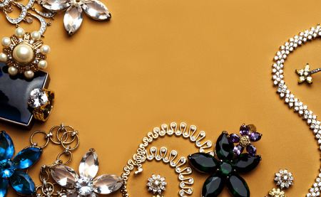 Beautiful jewelry with precious stones for women on a pink backgroundの写真素材