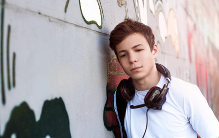 Stylish young man in headphones listening to music