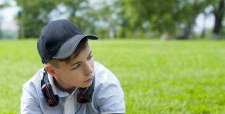 Pensive Young man with headphones listening to musicの写真素材