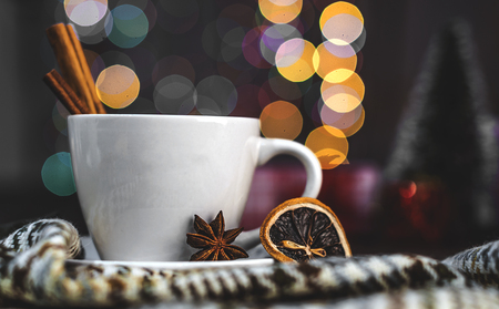 cup of coffee on a wooden table on a background of colored lightsの写真素材