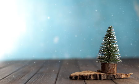 decorative christmas tree on a stand on a blue backgroundの写真素材