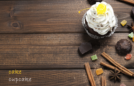chocolate cupcakes with cherries and cream on the tableの写真素材