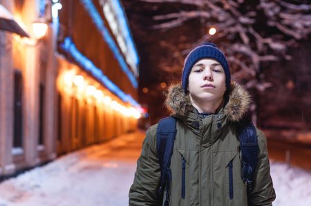 serious young man on a city street in winter