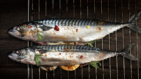 raw fresh mackerel stuffed with lemon on an iron grateの写真素材