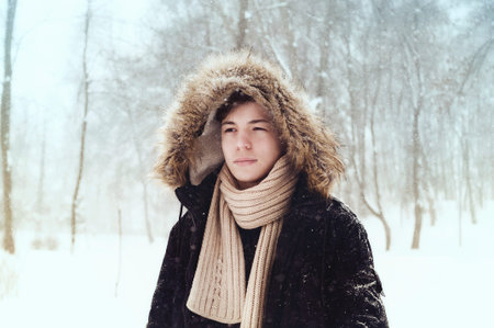 serious young man in the park in winter