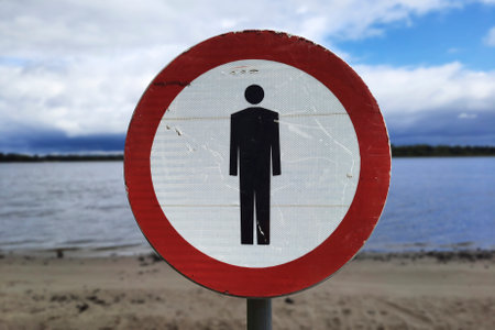 Nature without people. Pedestrians prohibited sign on bank of river.の写真素材