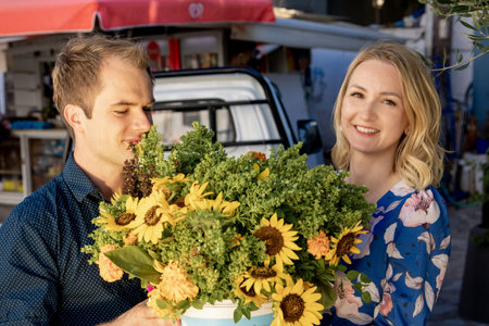 beautiful young couple with bouquet of flowers