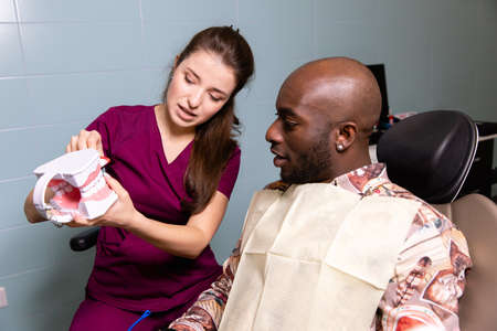 Doctor treats patient teeth in modern dental clinicの写真素材