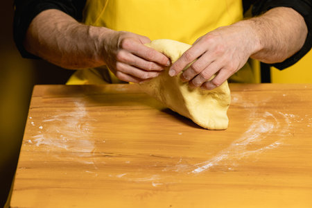 young attractive chef cook indian naan on yellow background