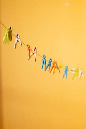 colored clothespin on the rope outdoorの写真素材
