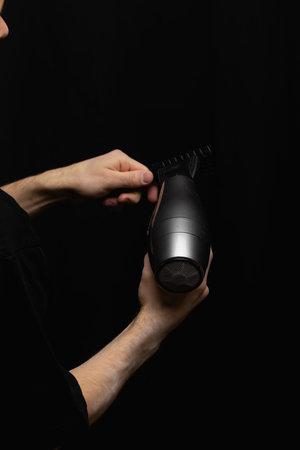 hair dryer and comb in barbers hands