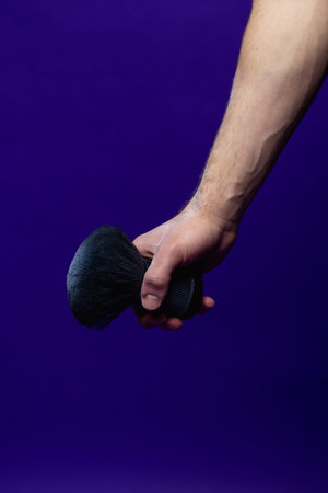 barber holding a brush for powder