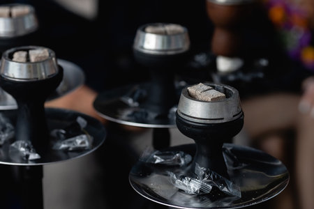 Smoldering embers in kaloud on hookah. Hookah smoking concept. Kalaud, charcoal tongs on hookah...