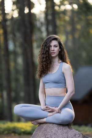 Beautiful girl meditating, yoga meditation practice in nature.
