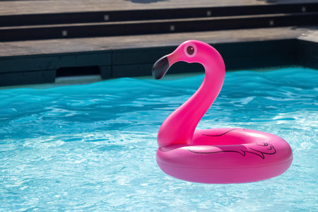 Vacation travel concept with inflatable pink flamingo float toy mattress