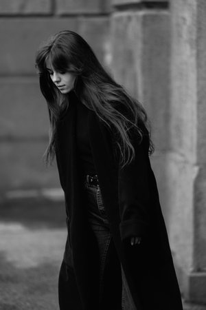 A young beautiful woman in a black coatの写真素材