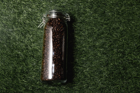 big glass jar with coffee seeds on white background isolatedの写真素材