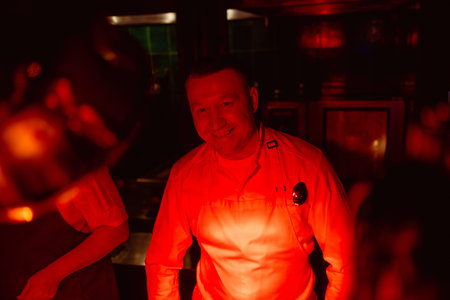 smiling caucasian cook man ready to cook in kitchen, wearing white apron. professional cook make...