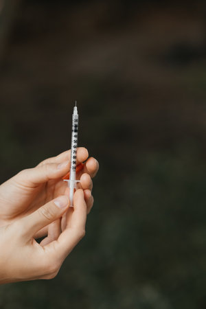 Cosmetic syringe in hands of a Cosmetologist and beauty industry doctor beauty procedure filler injection.woman getting cosmetic injection rejuvenating facial treatment concept. Aesthetic medical.の写真素材