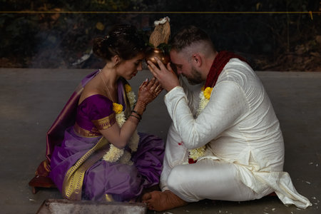 Wedding of a couple from Europe in India. A light skinned man in a traditional Indian men. white...