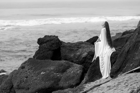 Beatifull young girl in wedding dress and on black beach in Varkala, Keralaの写真素材