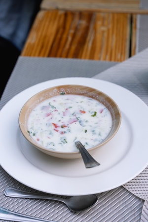 Indian raita sauce with yogurt, cucumber and mint on a gray background.の写真素材